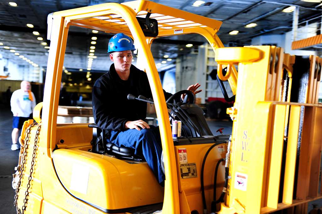 Forklift truck operator operating a forklift truck.
